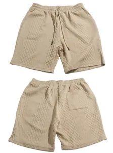 Detailed view of khaki men's textured shorts with diamond knit pattern and drawstring waist
