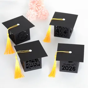 Detail of Class of 2026 hollow-out graduation candy boxes with yellow tassels