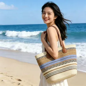 Detail of bohemian woven tote bag with colorful stripes and leather handles on the beach