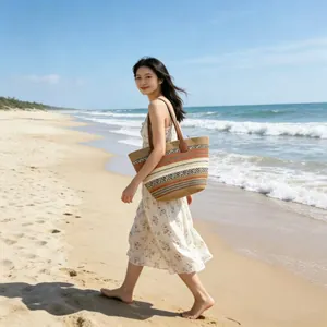 Detail of colorful woven tote bag with leather handles shown in a beach setting