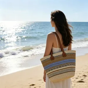 Detail of woven tote bag with geometric patterns against a sunny beach background