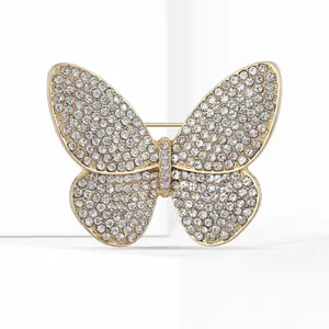 Macro shot of sparkling crystal butterfly brooch with golden metal base and rhinestones