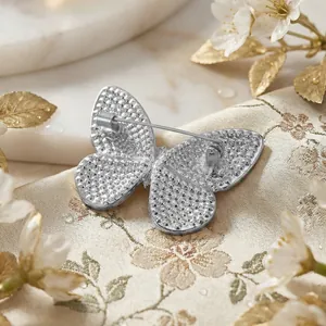 Detailed back view of the silver butterfly brooch showing pin fastener and metal texture