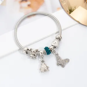 Silver charm bracelet with blue crystal beads, butterfly and little girl pendants