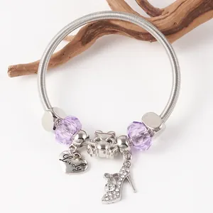 Detail of silver beaded spring bracelet with purple crystals and lovely heart charm