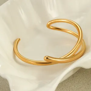 Minimalist 18K gold plated stainless steel knot cuff bracelet in a geometric design