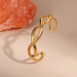 Polished 18K gold-plated stainless steel twisted cuff bracelet with crossover design