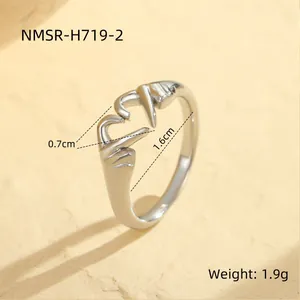 Macro detail of silver adjustable heart hands ring with size and weight measurements