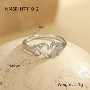 Detailed macro view showing dimensions and weight of hands making heart shape ring