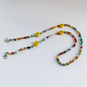 Colorful beaded strap with yellow smiley faces for face masks or glasses, with metal clasps