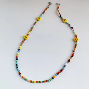 Colorful beaded lanyard with smiley face charms and lobster clasps on white background