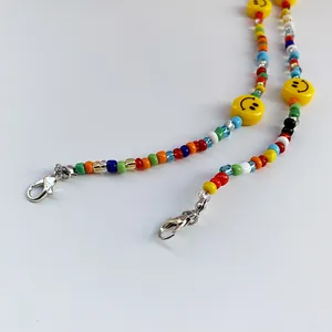 Colorful beaded lanyard with yellow smiley faces and silver lobster clasps for face masks