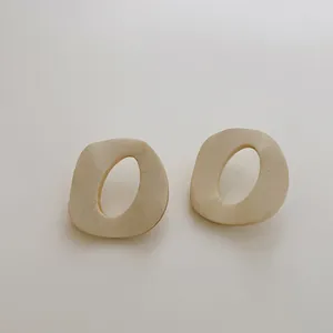 Dettaglio della texture in legno naturale di questi orecchini ovali geometrici