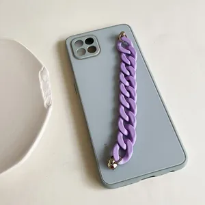 Gray-blue matte phone case with purple chunky plastic chain handle and silver rivets