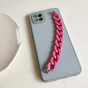 Detail of blue grey phone case featuring a chunky matte pink plastic chain handle
