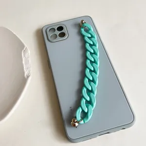 Close-up of matte mint green chunky chain handle on a blue silicone phone case