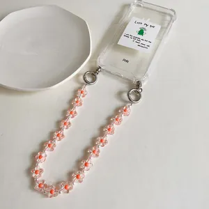 Custodia per telefono trasparente con laccetto di perline a fiori rosa e fermagli