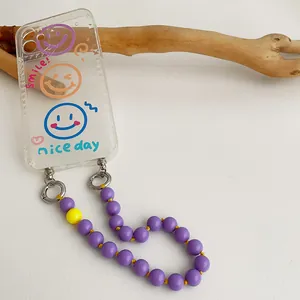 Transparent phone case with colorful smile pattern and purple beaded charm strap