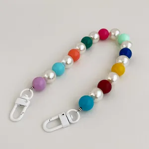 Colorful resin bead and pearl phone strap with metal lobster clasps on white background