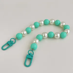 Detail of mint green and pearl beads phone strap with matching lacquer lobster clasps