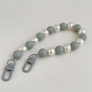 Detail of candy color beaded phone strap with gray lobster clasps and pearls