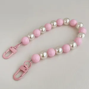 Detail of pink matte beads and white pearls mobile strap with matching lobster clasps