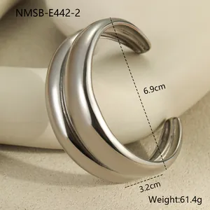 Macro view of wide silver stainless steel cuff showing dimensions of 6.9cm diameter and 3.2cm width
