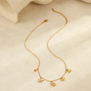 Gouden oceaan ketting met zeester schelp en emaille hanger op een stenen achtergrond