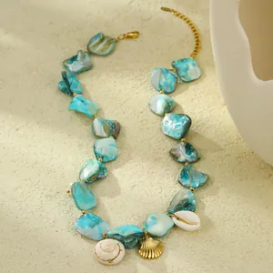 Ocean-inspired titanium steel necklace with turquoise shell pieces and gold seashell charms