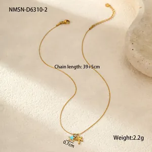 Detail of gold seashell necklace featuring double star pendants and tiny zircon stone