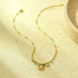 Detail of gold shell necklace featuring turquoise beads and sparkling starfish charms