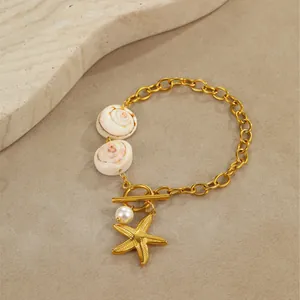 Detailed view of ocean-style gold necklace with natural shells, pearl and starfish charm