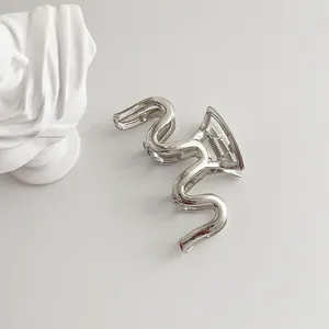 Minimalist silver wavy metal hair claw clip with a high-polished mirror finish for women