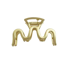 Minimalist matte gold wave hair claw clip for elegant updo hairstyles in 45-degree view