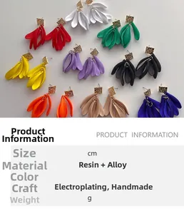 Macro detail of resin petal earrings in multiple colors with gold hammered metal accents