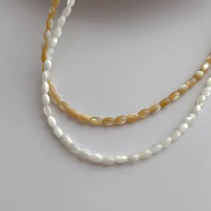 Minimalist shell rice bead necklaces in white and amber tones for beach style