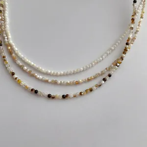 Detailed close-up of 2mm natural freshwater shell pearl necklaces in gradient colors