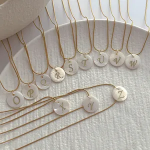 Golden snake chain necklace with natural shell pendants featuring English letter engravings