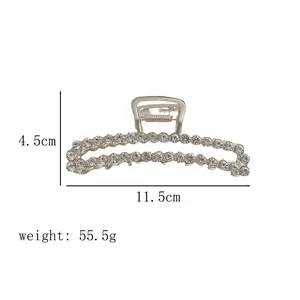 Detailed view of silver metal hair claw with dimensions 11.5cm length and zircon inlay