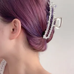 Elegant silver metal claw clip with rows of sparkling zircons worn on purple hair