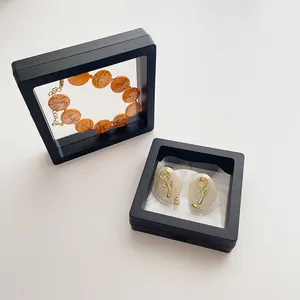 Close-up of marble bead bracelet and rose earrings in black PE film suspension boxes