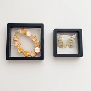 Close-up of beaded bracelet and rose earrings in black PE film floating display boxes