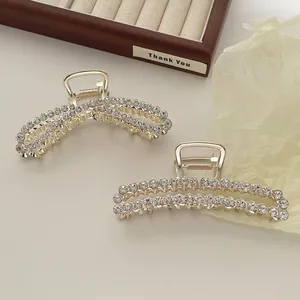 Elegant gold metal hair claw clips with sparkling cubic zirconia and French style design