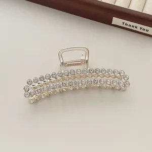Detailed close-up of large silver alloy claw clip with double rows of sparkling rhinestones