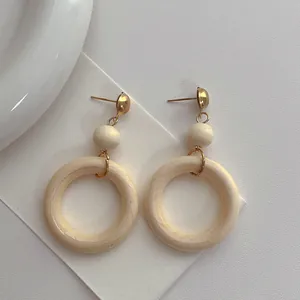 Vintage wooden hoop earrings with natural wood beads and gold metal accents for women