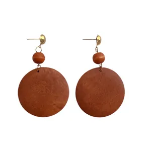 Chunky bohemian wooden hoop earrings with gold studs and orange-brown wood beads