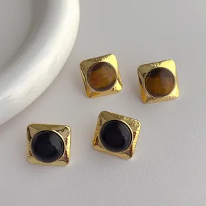Retro geometric square gold stud earrings featuring tiger eye and black stones