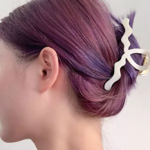 Maillard style acetate hair claw in ivory white with wave pattern on purple hair