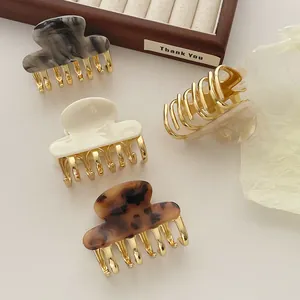 Set of four tortoiseshell and cream acetate hair claws with premium gold metal teeth