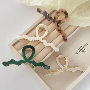 Maillard style acetate hair claws in leopard and marble patterns with golden metal springs